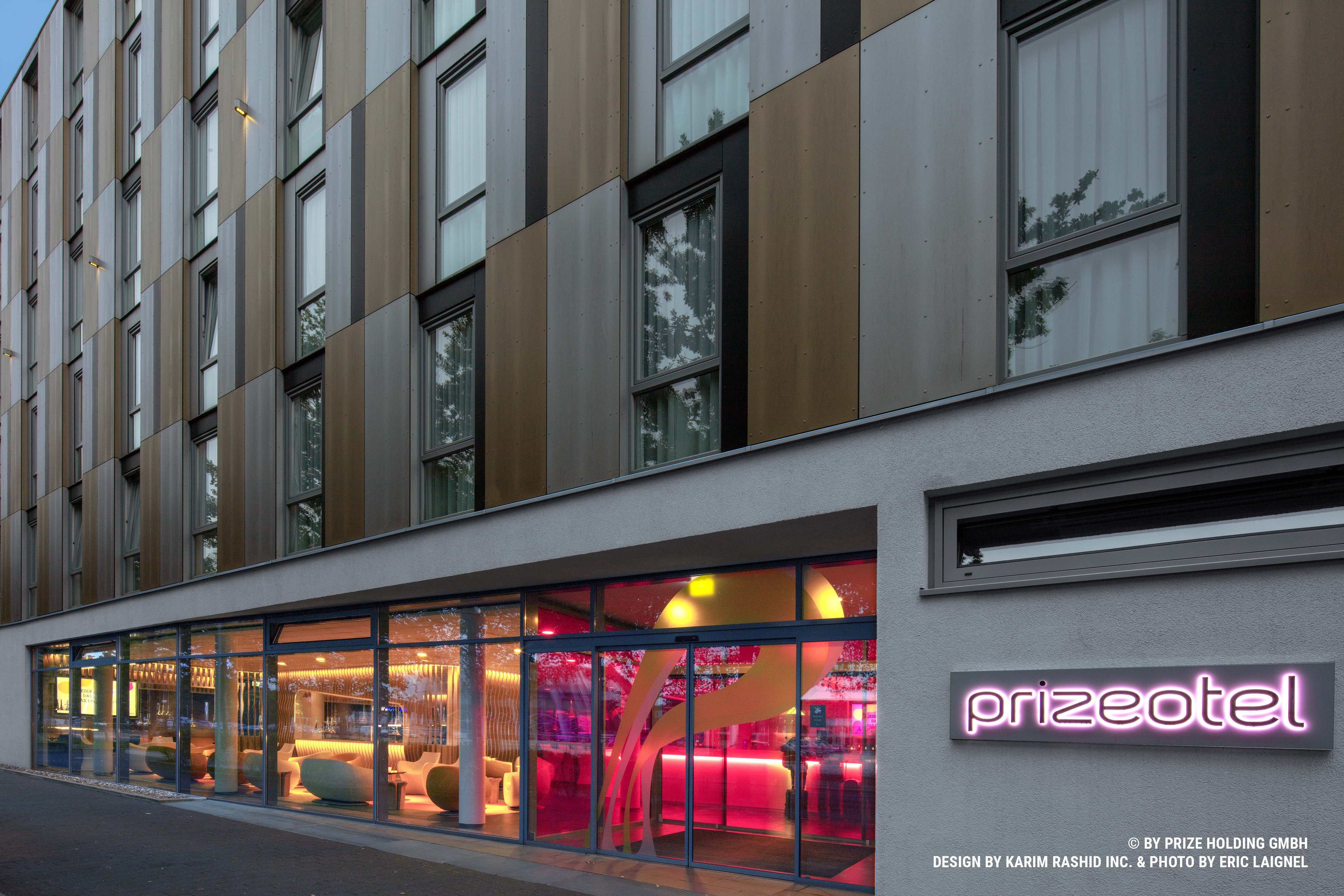 Facade of the prizeotel building Bremen-City with a pink LED logo